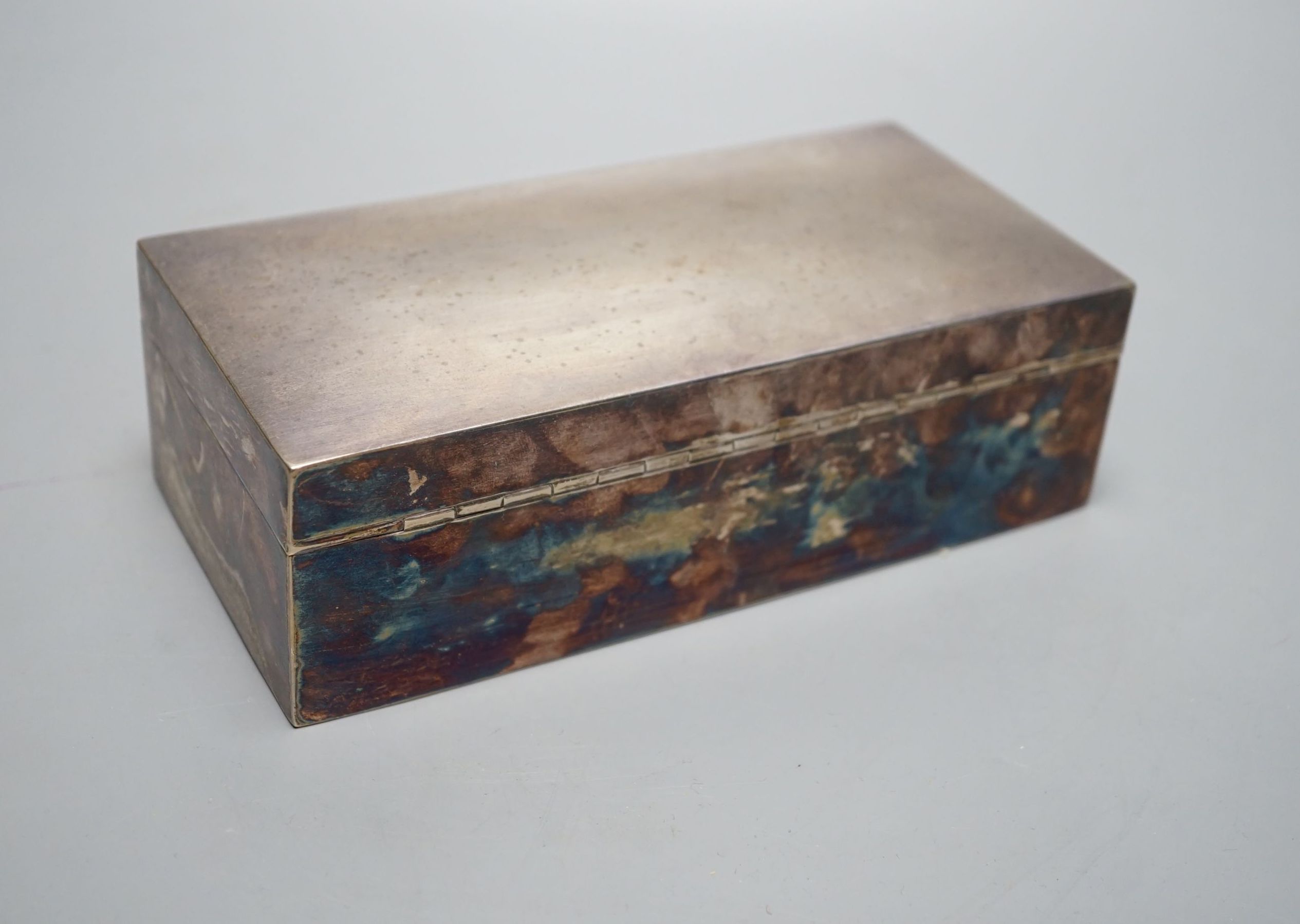 A George V silver mounted rectangular cigarette box, Birmingham, 1922, 18.6cm.